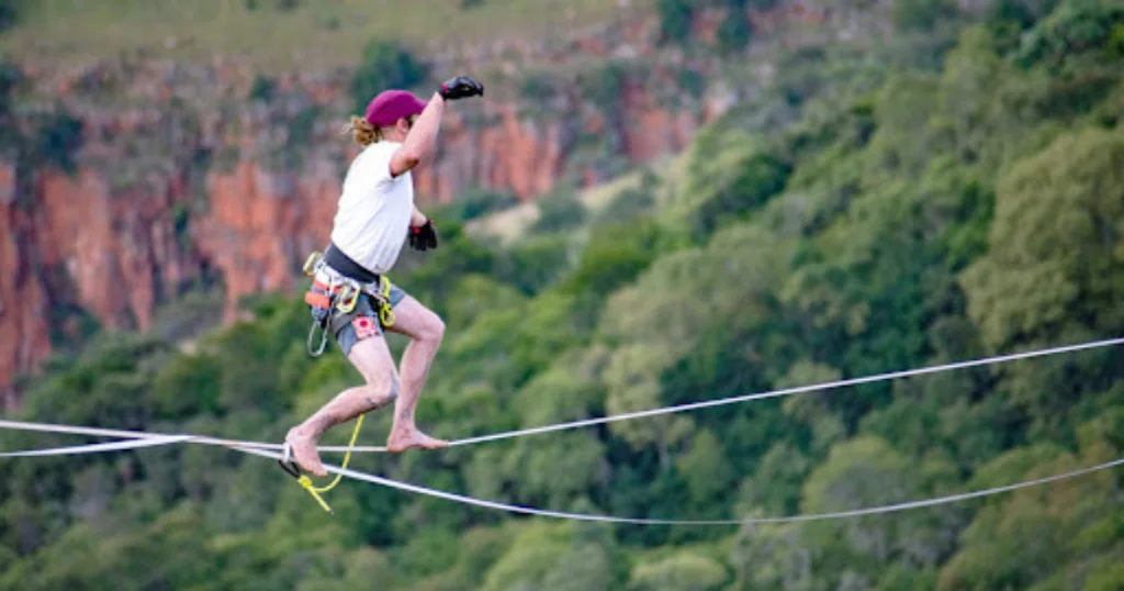 Wesley walking a highline at Mayhem Mountain Festival