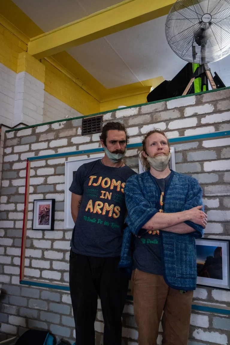 Two tjoms repping their Tjoms in Arms shirts
