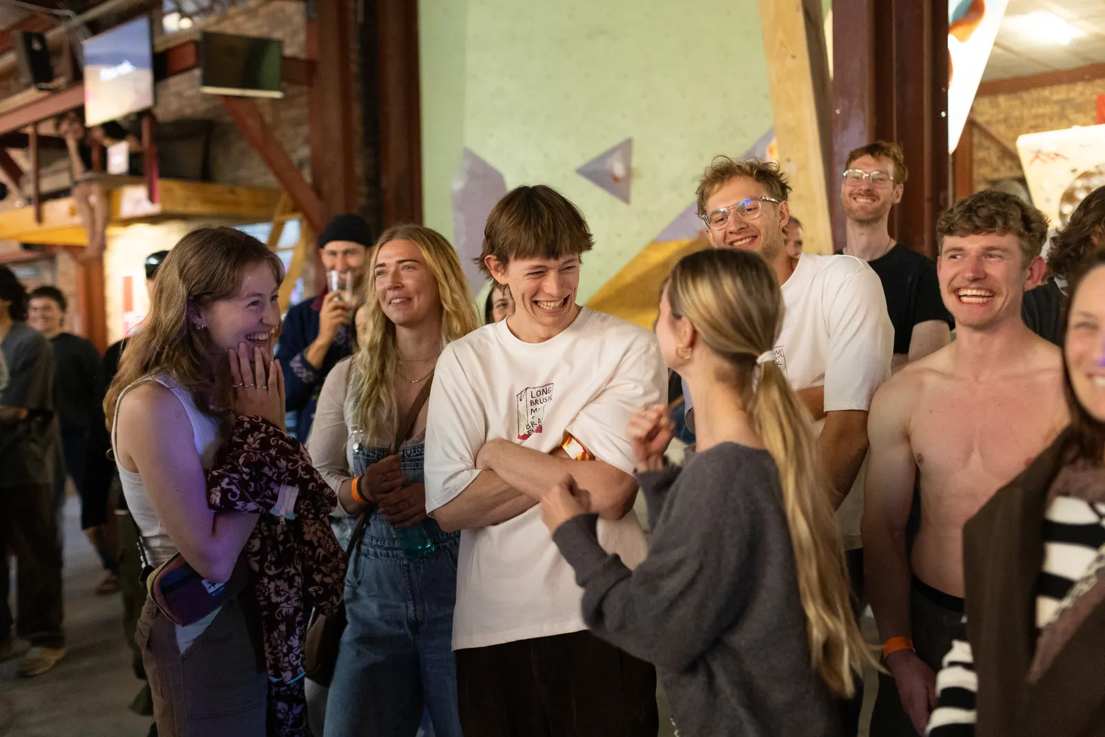 A group of climbers laughing together in the gym