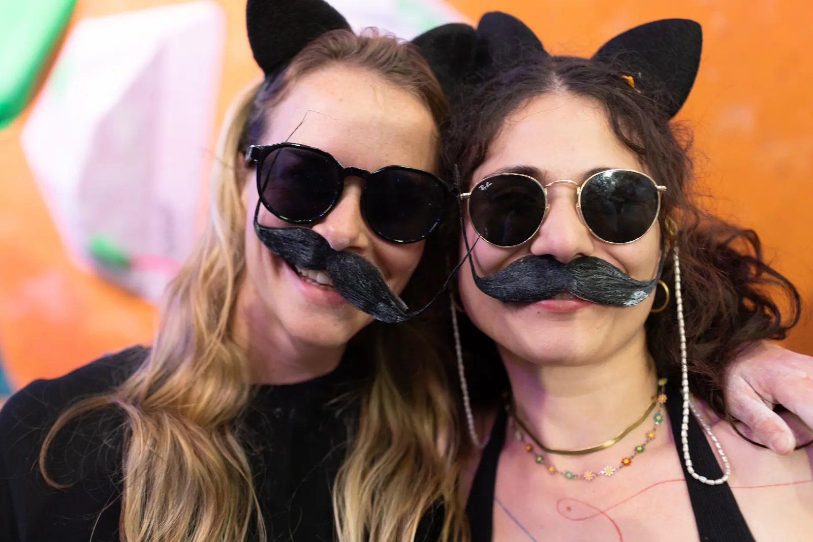 Two climbers in cat ears, sunglasses and fake moustaches