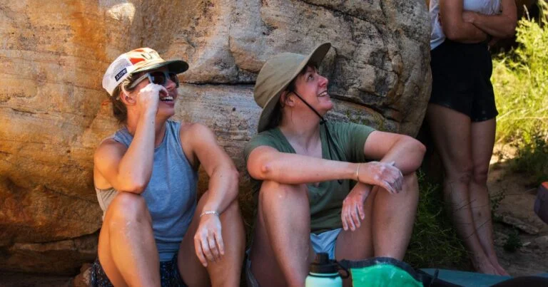 Ladies sitting by boulder